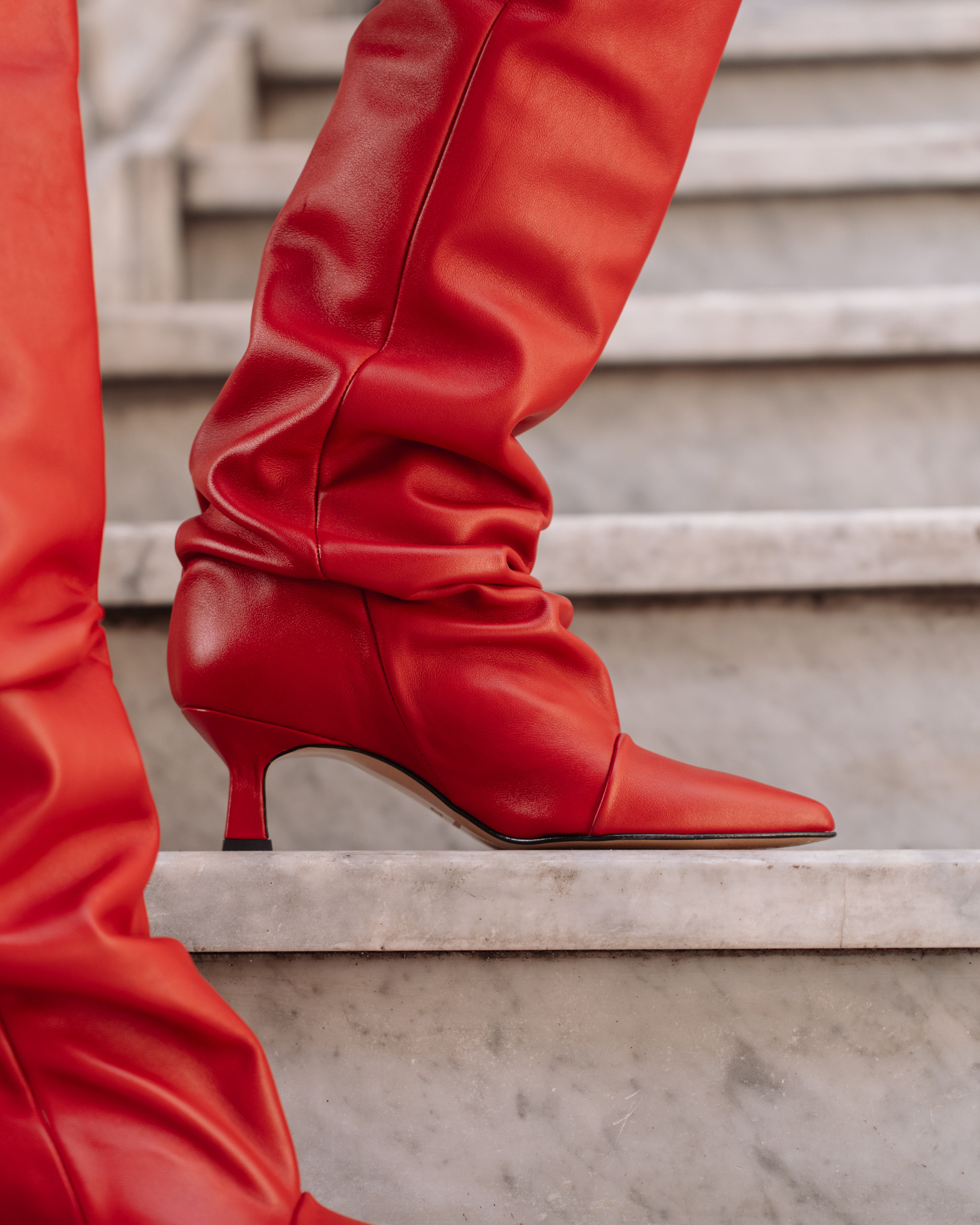 JENNIFER - High knee tubular boot in real red leather with draped effect. 5 cm heel.